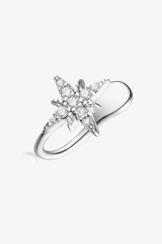A stunning silver ring featuring a star design with intricate diamond detailing in a choosing jewelry earrings guide