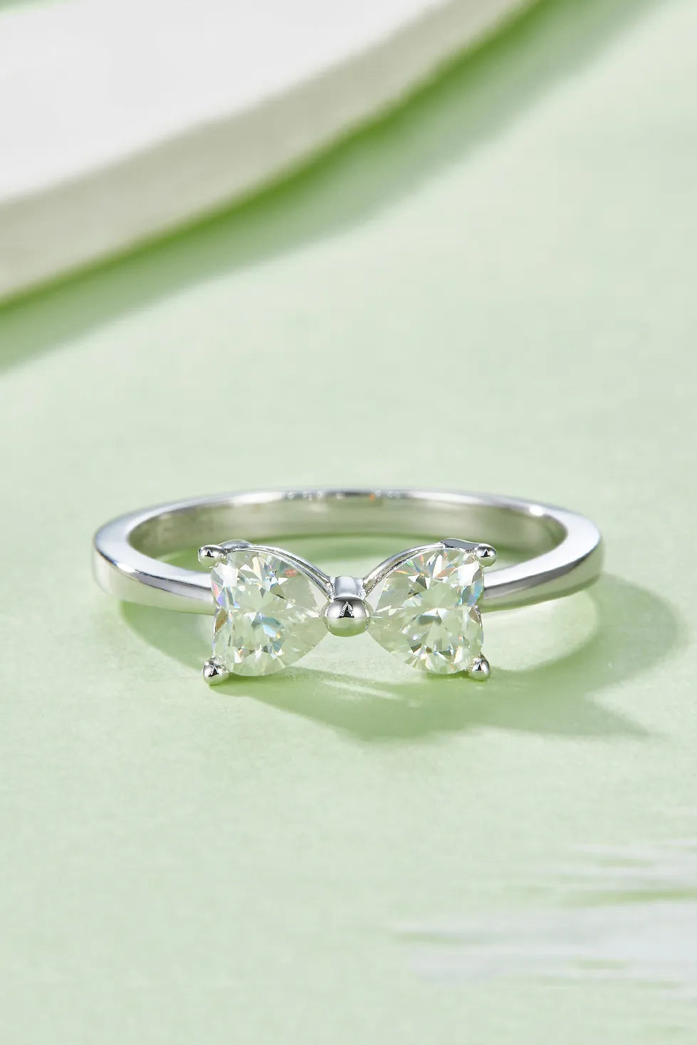 1 carat moissanite bow ring with a delicate design featuring two stones and a polished band