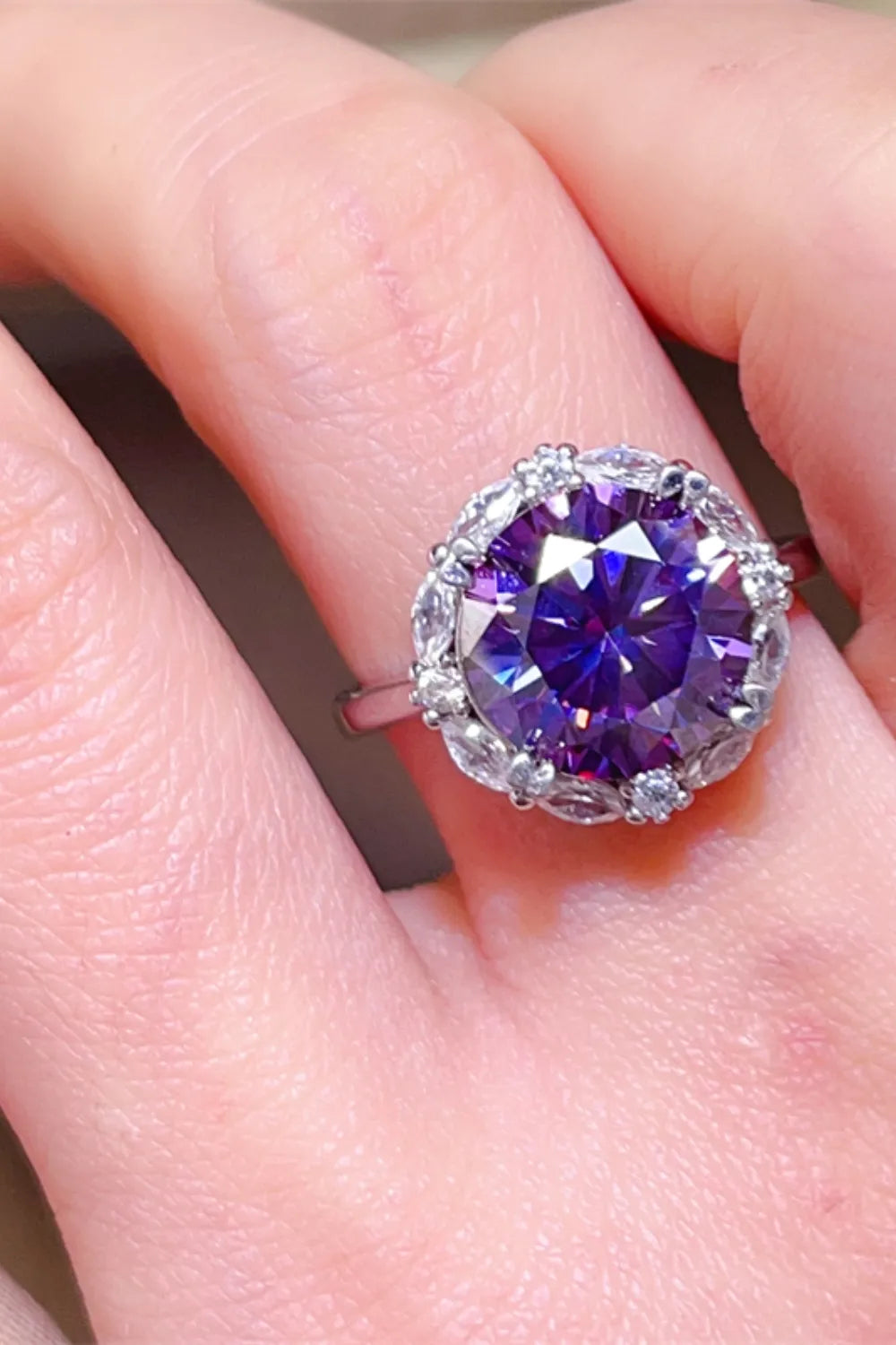 Stunning 5 carat moissanite ring with a purple centerpiece and delicate accent stones on a silver band