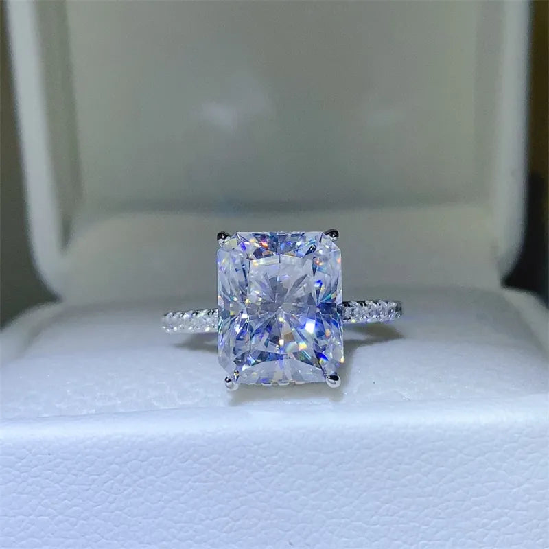 5 carat moissanite ring with a radiant cut and sparkling band set on a plush white display box