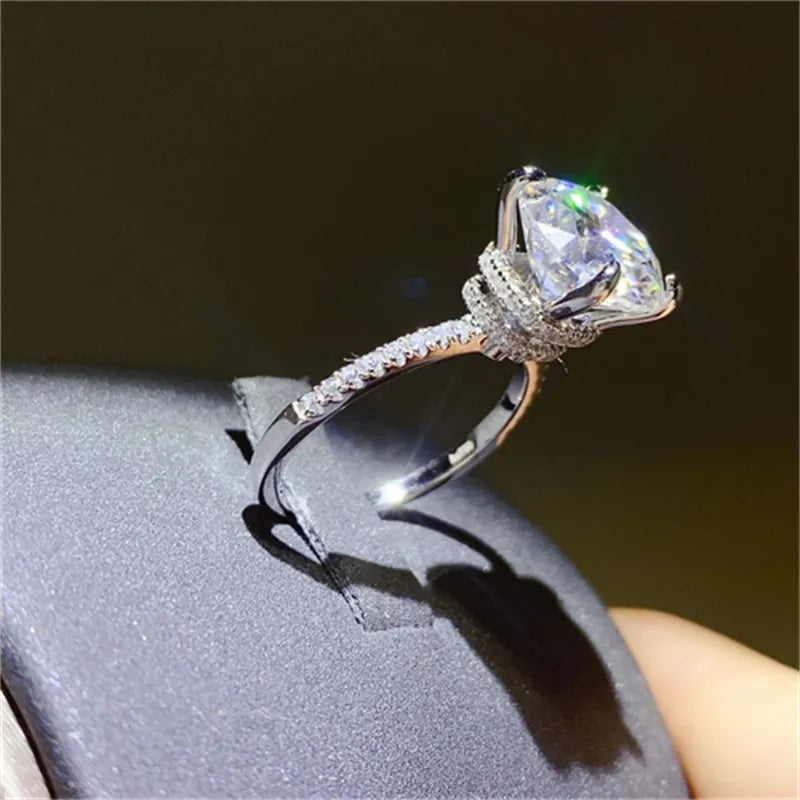 Elegant 5 carat moissanite ring featuring a brilliant cut stone and glittering band details