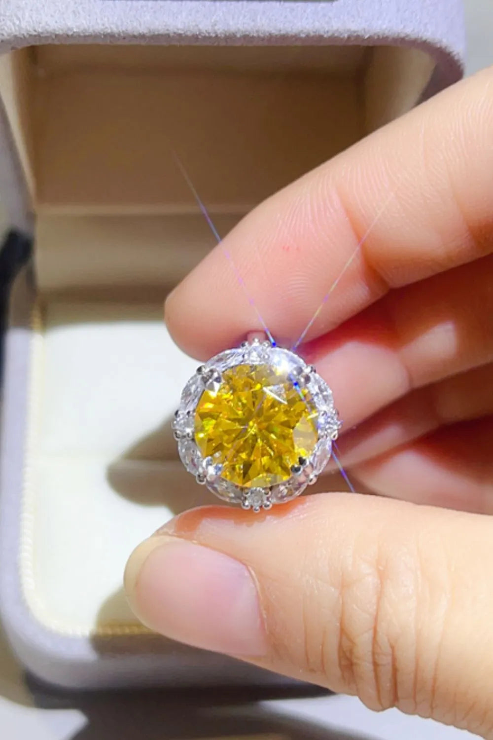 Stunning yellow 5 carat moissanite ring with a sparkling halo design showcased in a hand