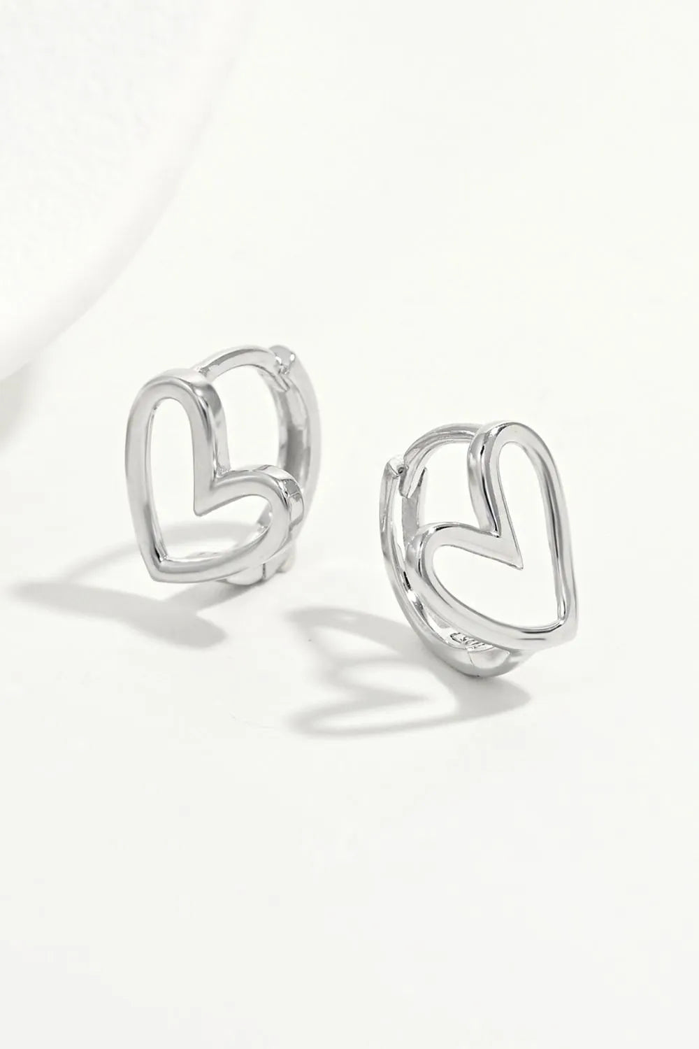 925 sterling silver heart earrings with a delicate heart-shaped design and polished finish