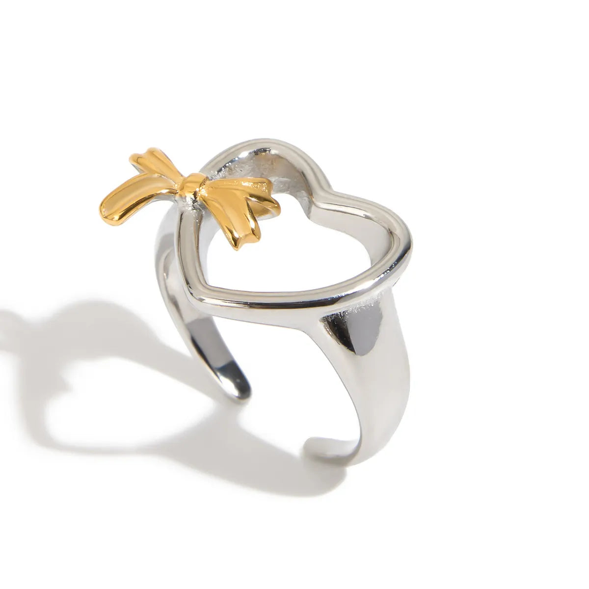 Trendsi adjustable two-tone heart ring with a shiny silver band and a gold bow accent