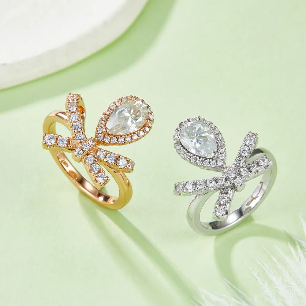 Two affordable moissanite rings in gold and silver featuring sparkling bow designs