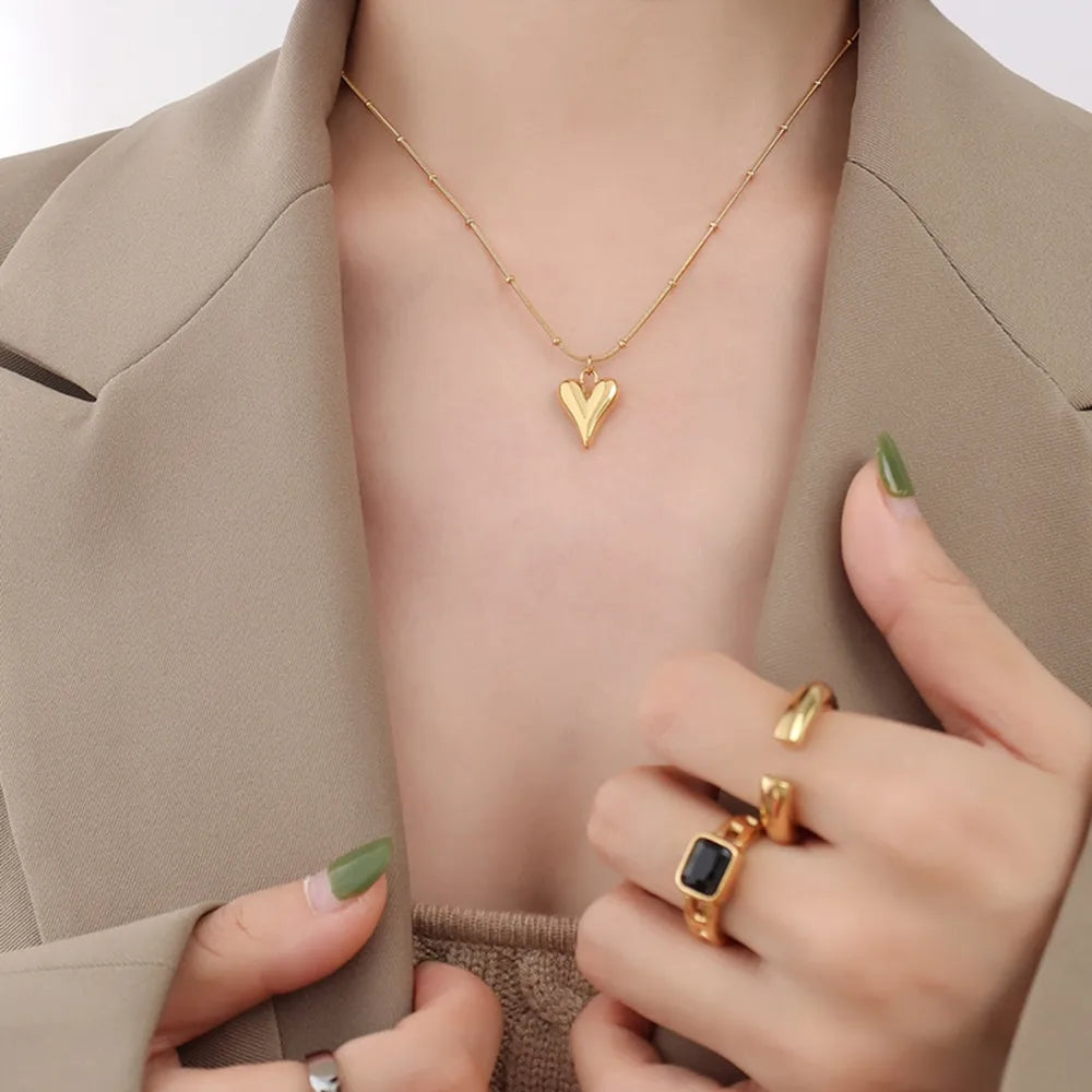 Trendsi durable heart pendant necklace in gold worn with stylish attire