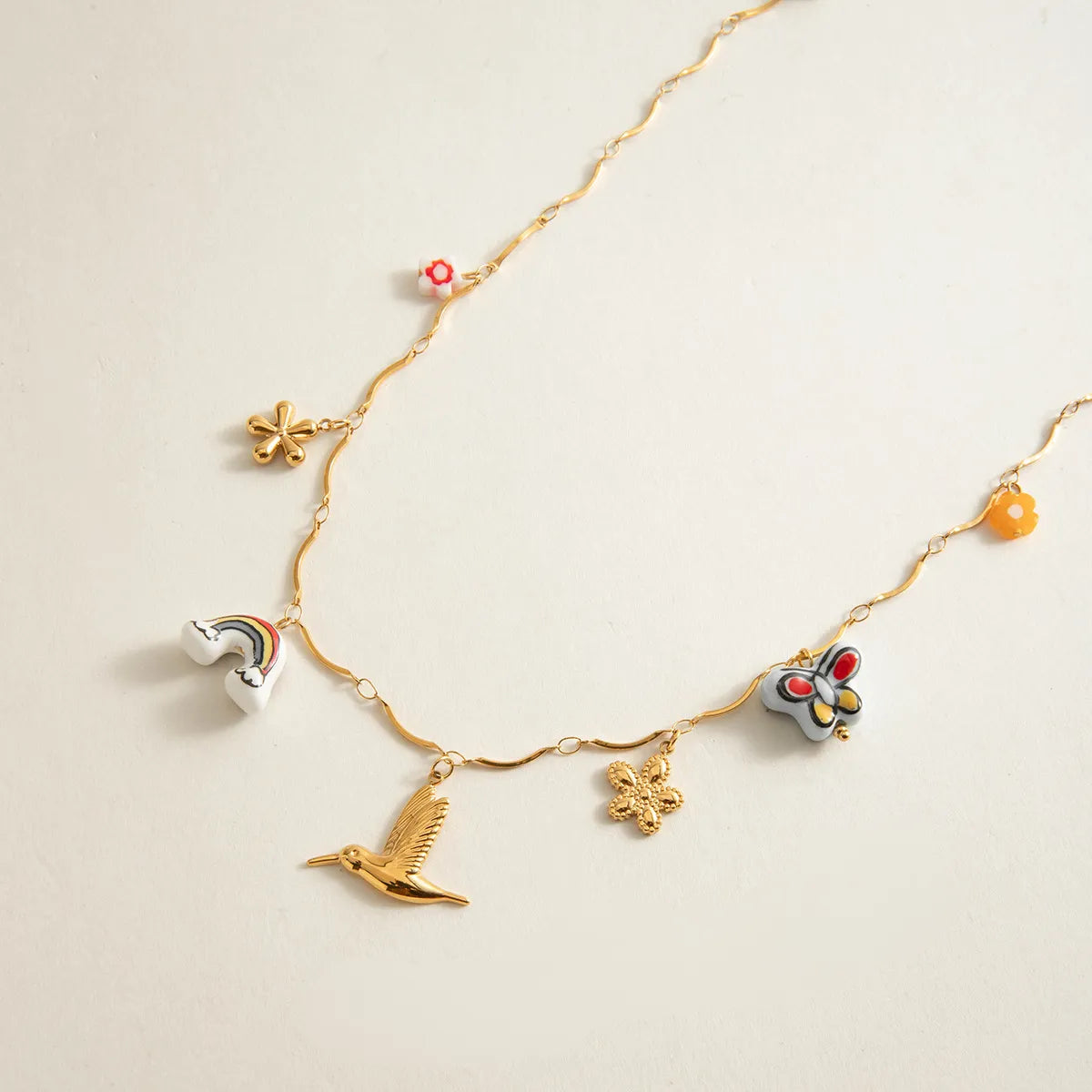 Trendy charm necklace featuring colorful charms and an elegant gold pendant necklace design