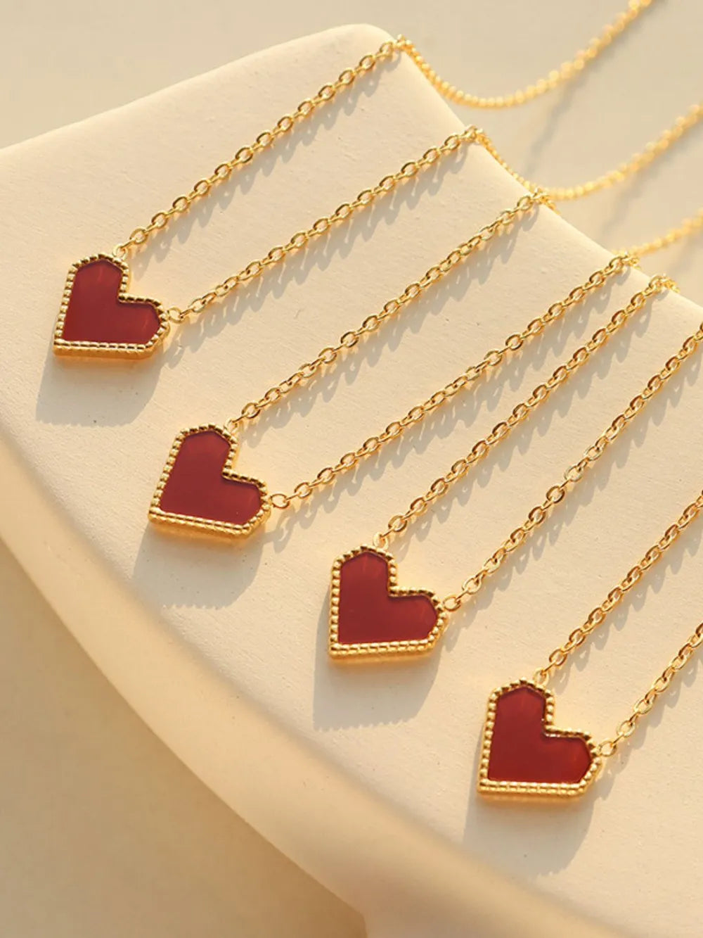 Trendsi elegant heart jewelry featuring gold chains with red heart-shaped pendants