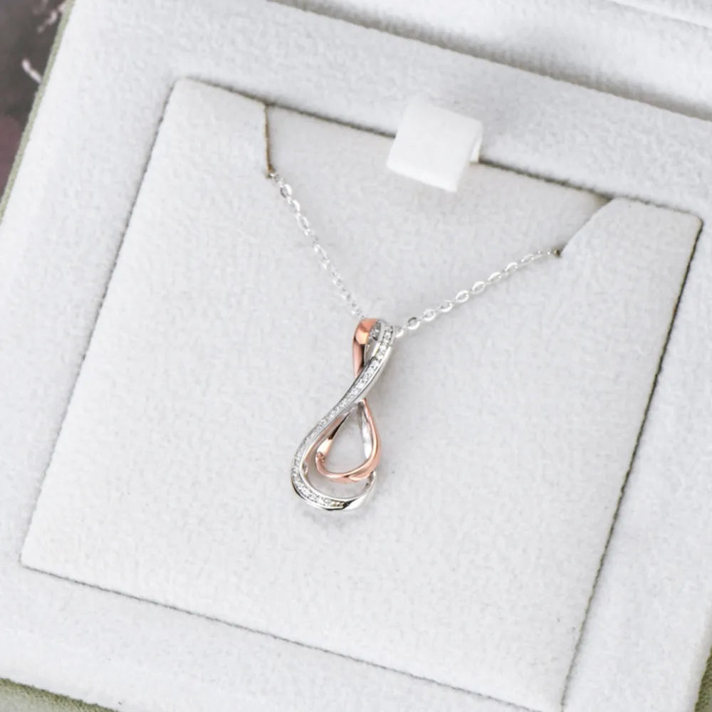 Elegant infinity necklace for women featuring silver and rose gold intertwined design with sparkling accents