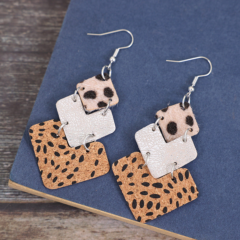 Trendy fashion earrings for women featuring layered geometric designs in animal print and textured materials