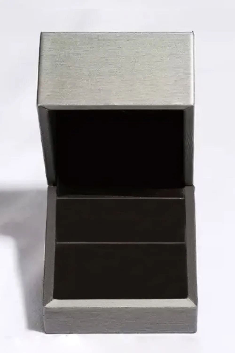 Elegant open jewelry box designed for a glamorous green gemstone ring