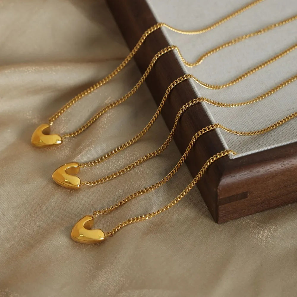 Elegant heart pendant jewelry in gold with delicate chains for a stylish look
