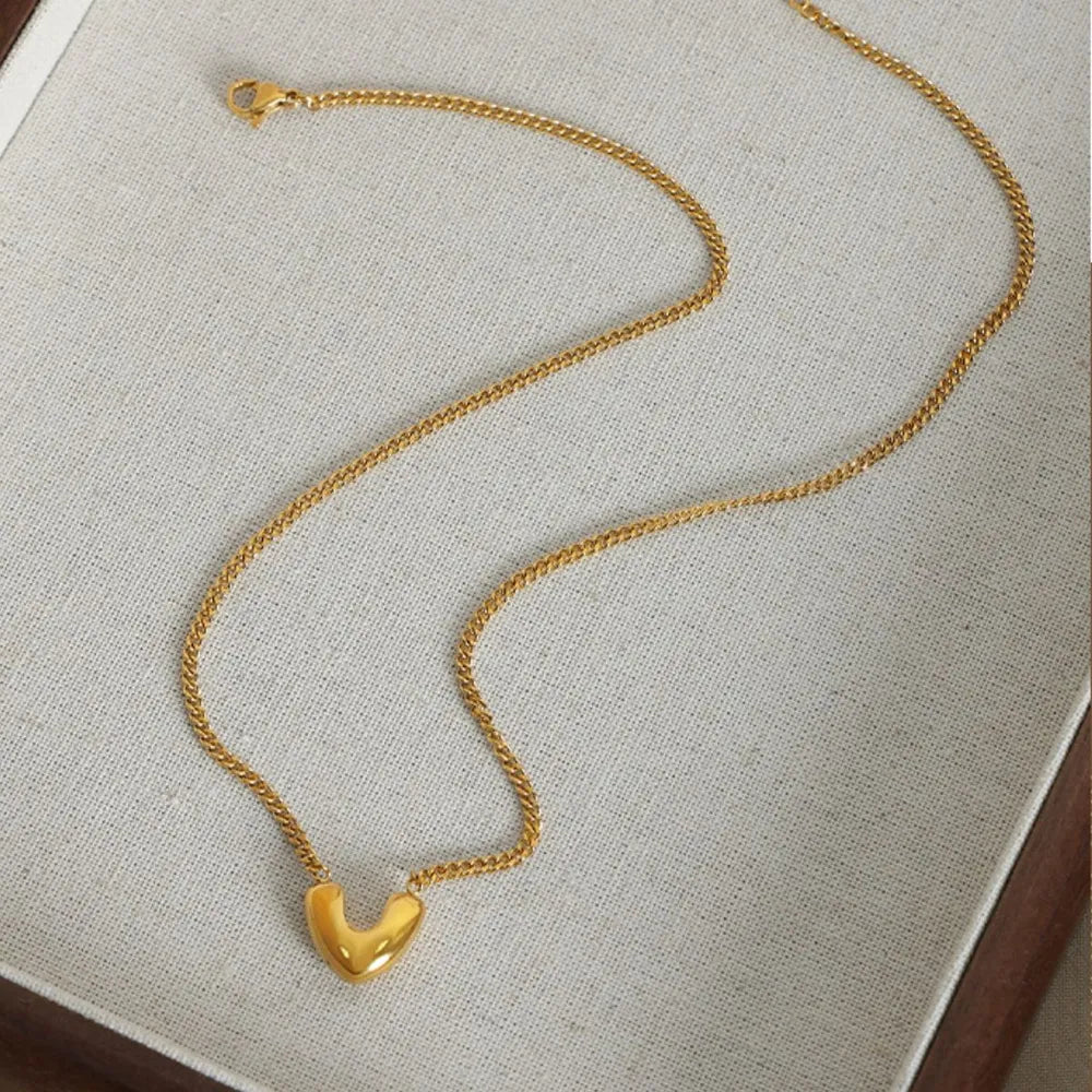 Elegant gold heart pendant jewelry on a delicate chain, perfect for daily wear or special occasions
