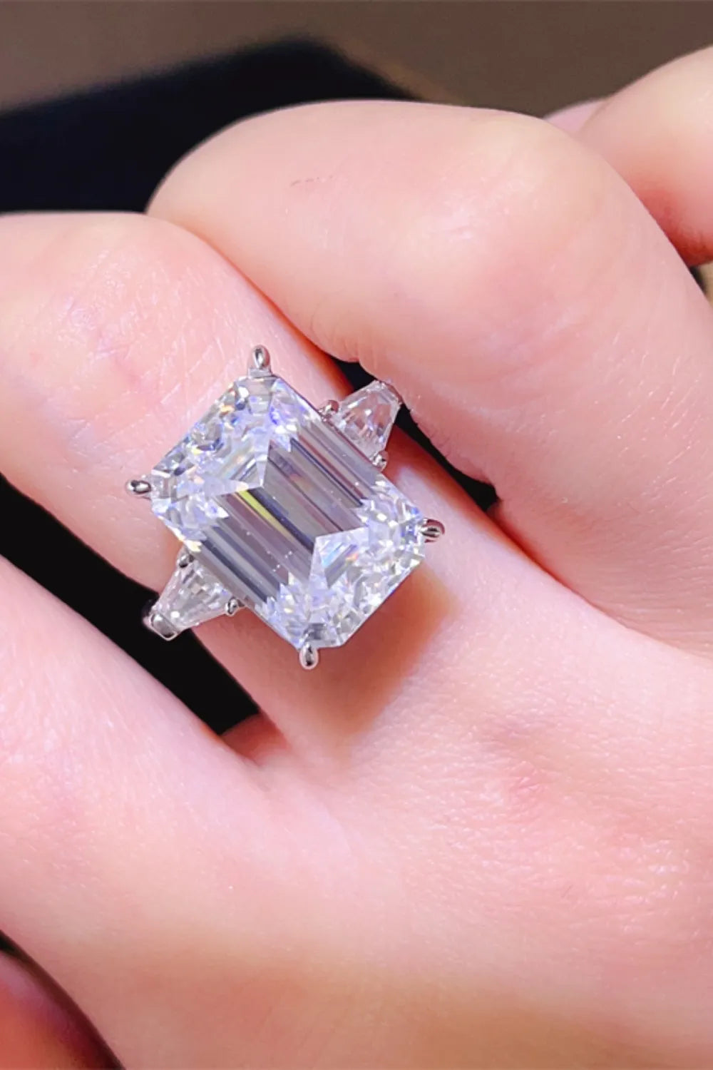 Elegant luxury moissanite jewelry ring featuring a stunning emerald cut stone with side accents