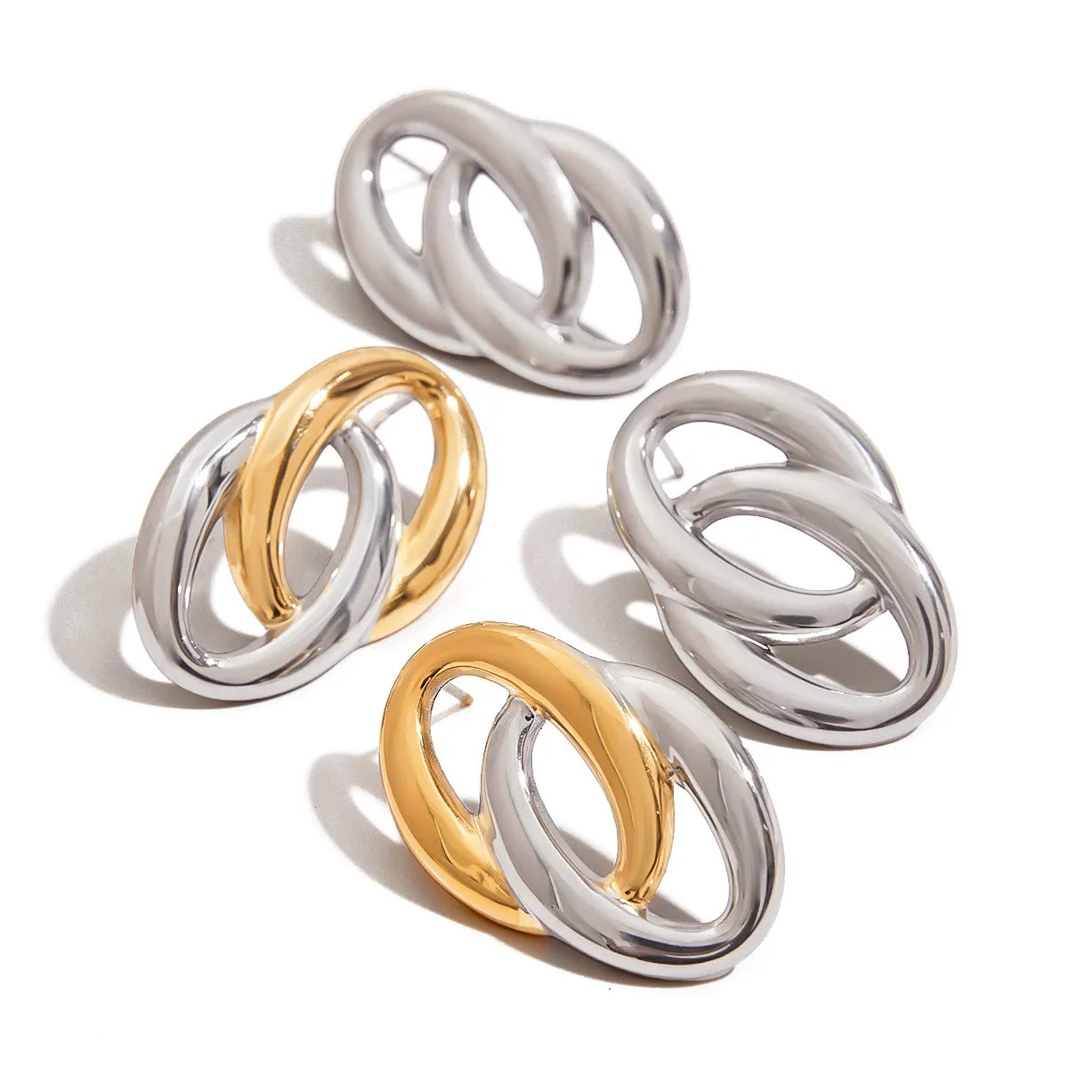 Trendsi modern twist hoop earrings in silver and gold with sleek intertwined design