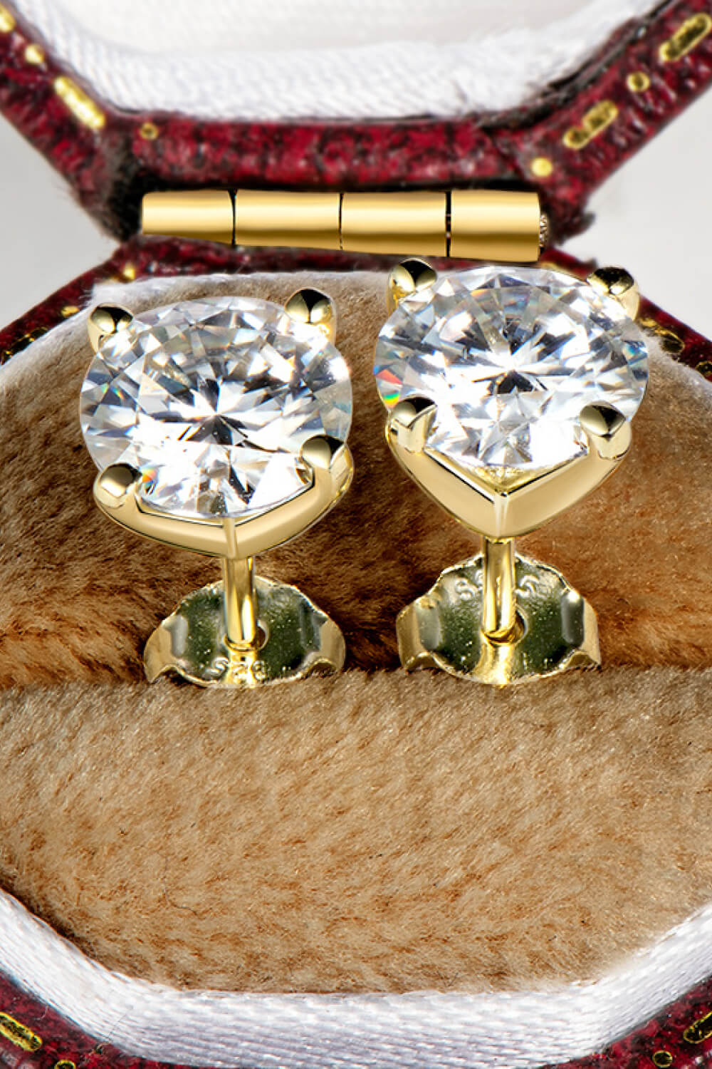 Elegant gold 1 carat moissanite stud earrings set in a plush jewelry box