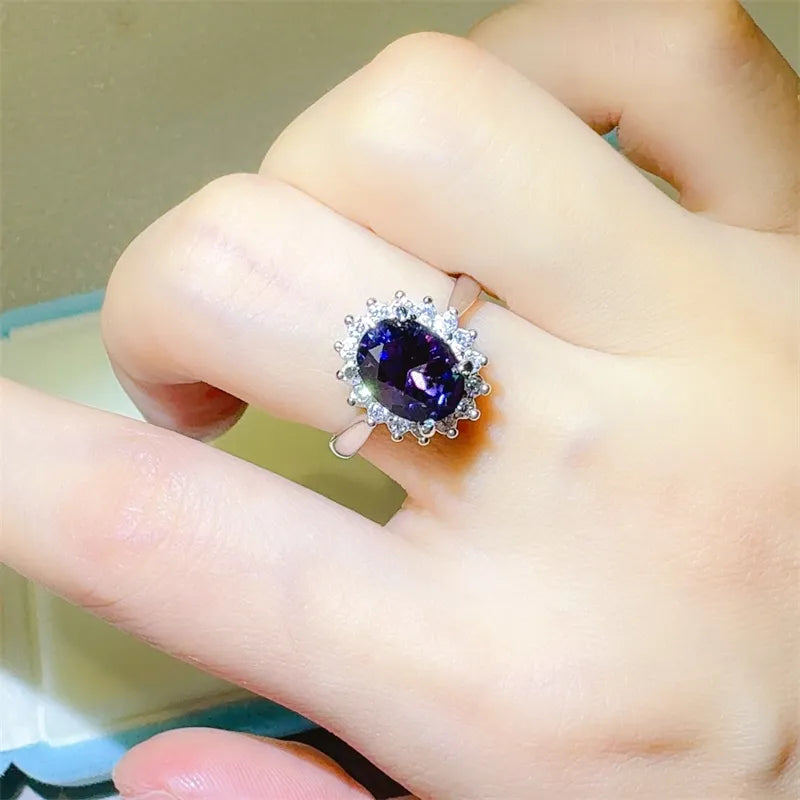Elegant 2 carat moissanite ring with a stunning oval purple center stone and surrounded by sparkling accents