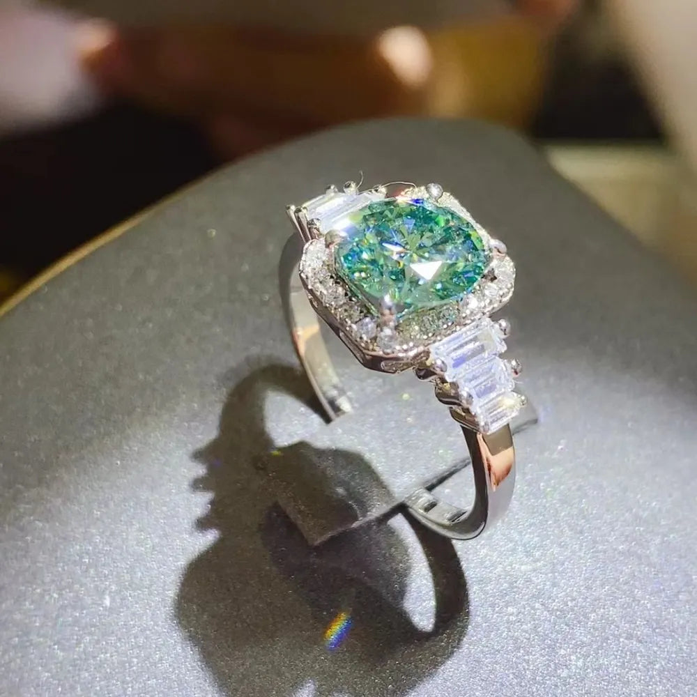 Elegant 3 carat moissanite engagement ring featuring a stunning green center stone and baguette diamond accents