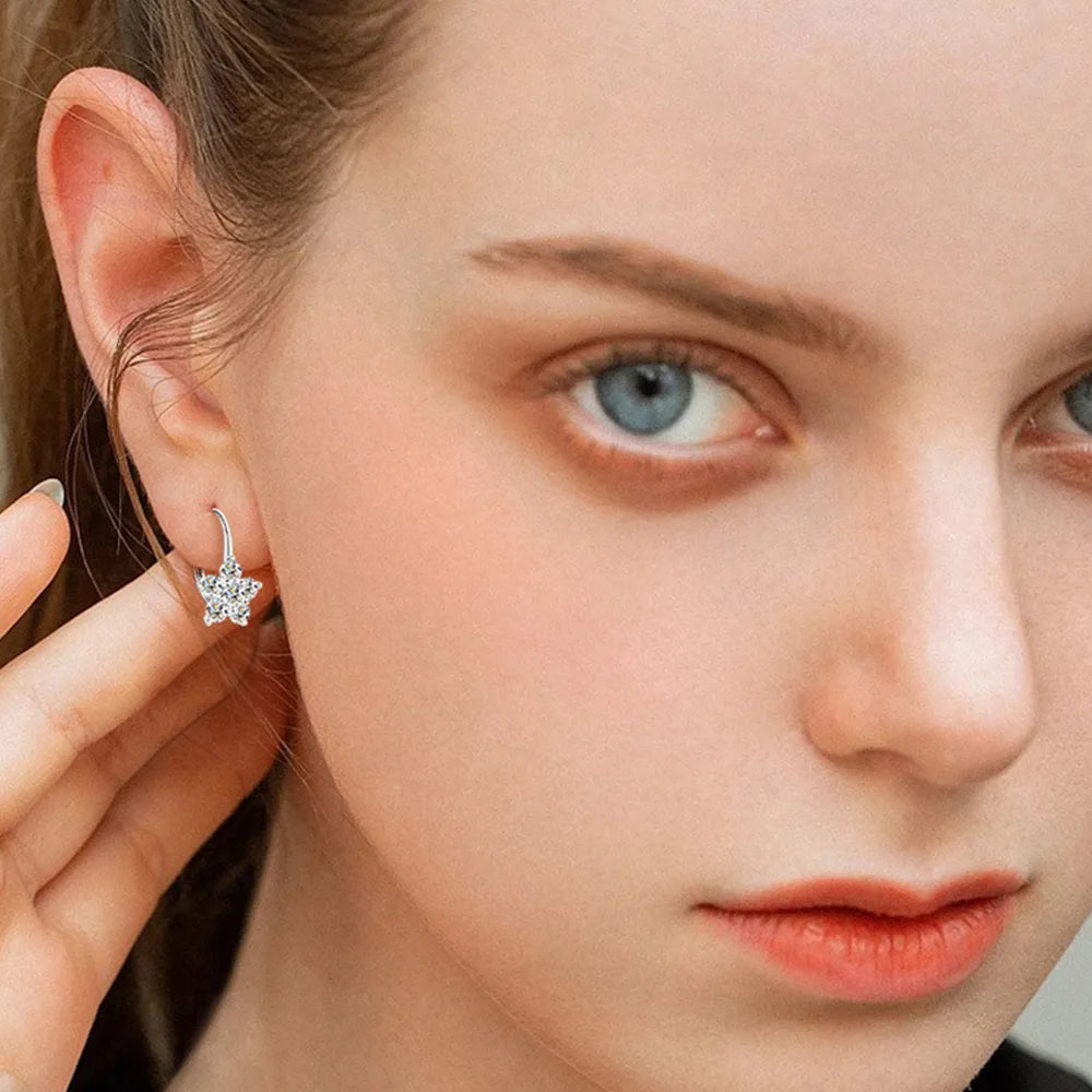 Trendsi Moissanite flower earrings showcased on a model with blue eyes and a natural makeup look