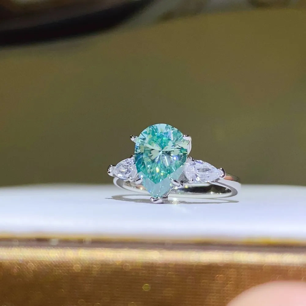 Elegant 2 carat moissanite silver ring featuring a pear-shaped center stone with side accents