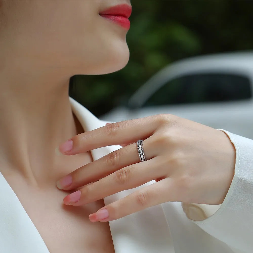 Stylish woman wearing a moissanite wedding band with elegant design and sparkling details