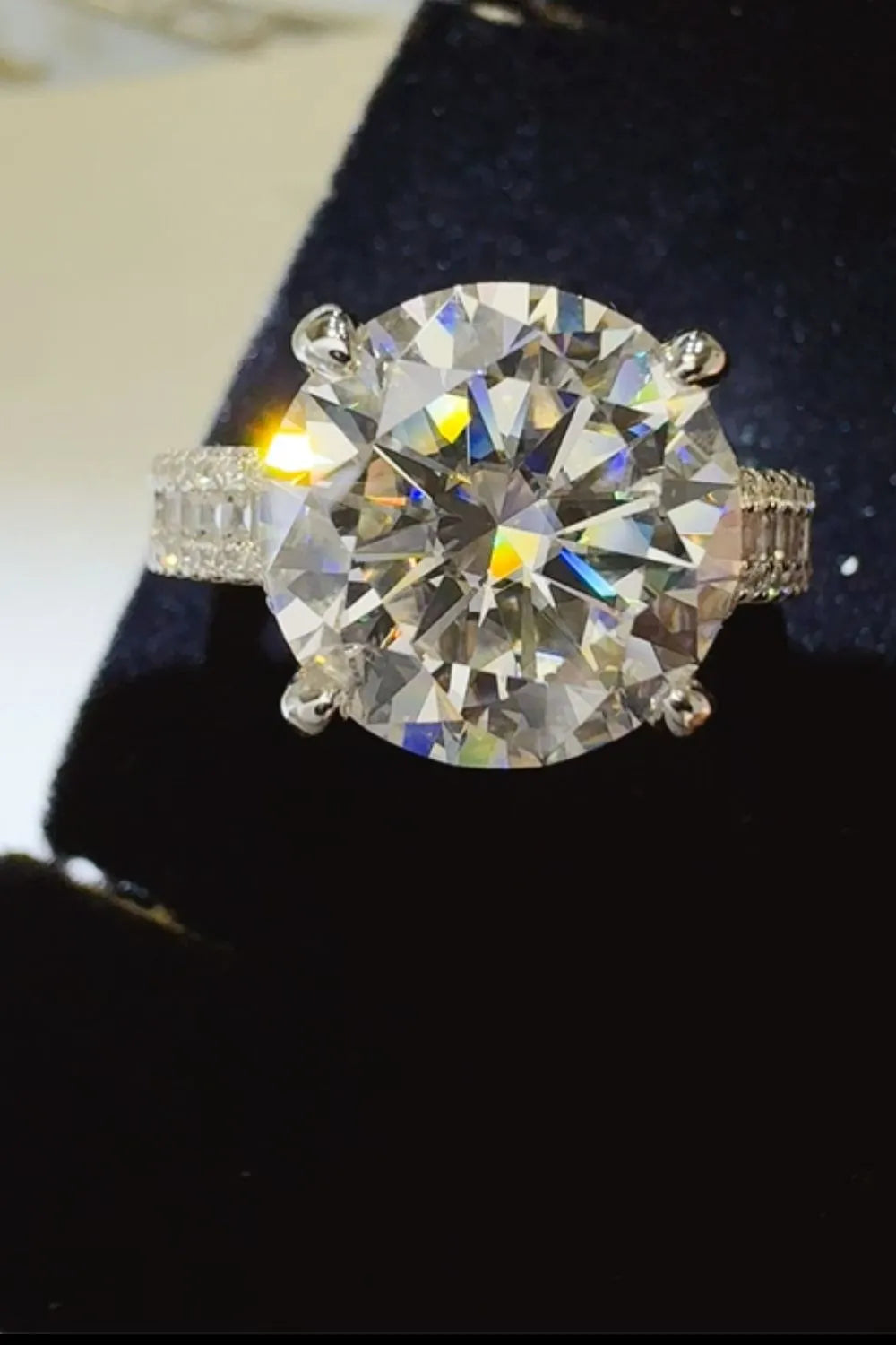 Elegant moissanite wedding jewelry ring with a large sparkling center stone and diamond accents