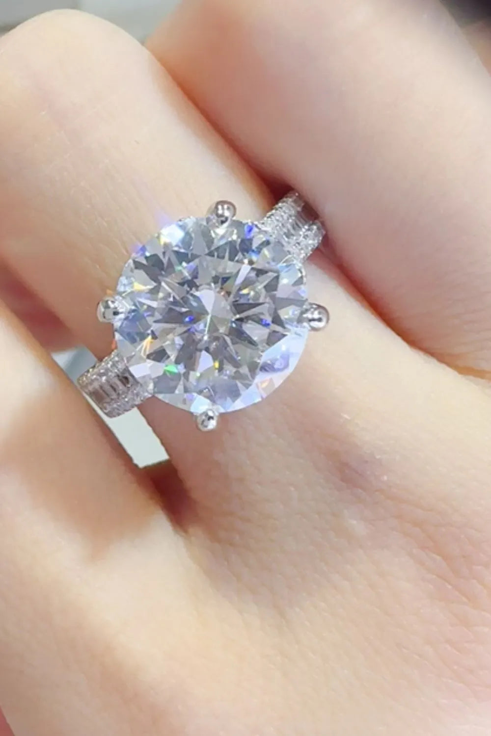 Stunning moissanite wedding jewelry engagement ring with a round brilliant cut and intricate band design