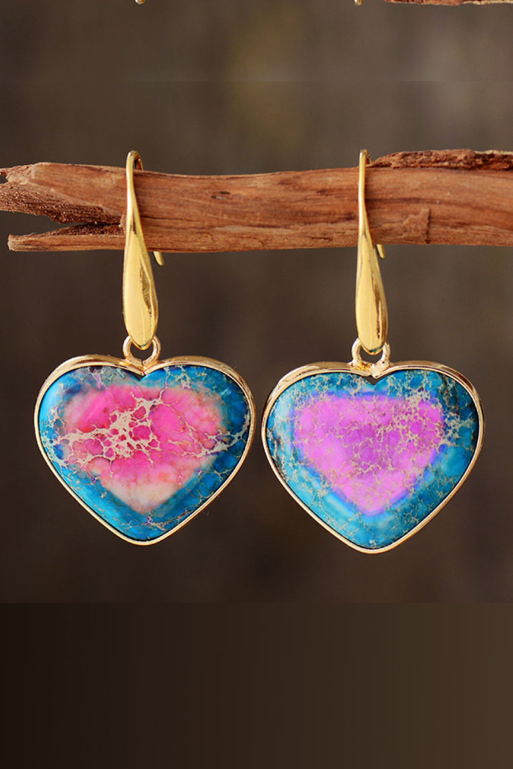 Natural stone heart earrings with colorful blue and pink patterns, set in gold-tone metal.