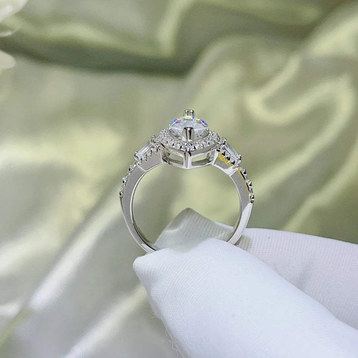 Elegant pear shaped moissanite ring with intricate detailing and sparkling accents