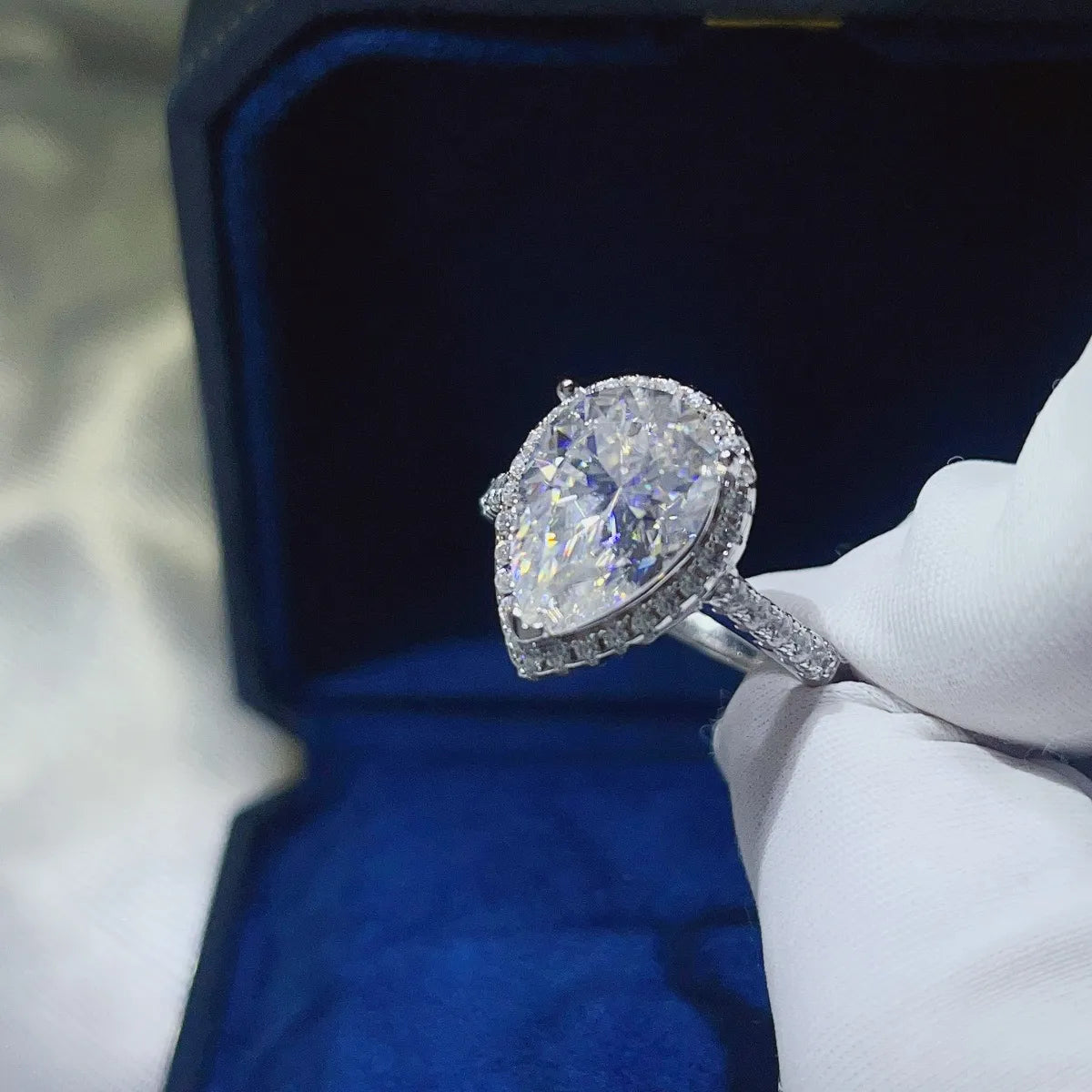 Trendsi pear shaped moissanite ring set in a silver band with sparkling accents