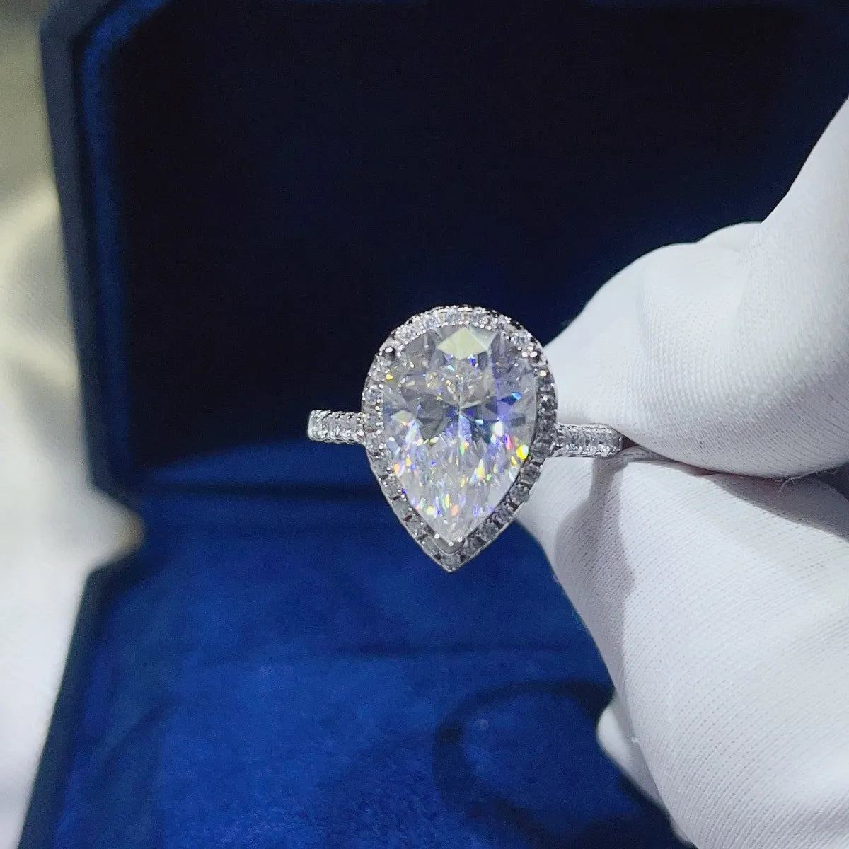 Elegant pear shaped moissanite ring set in white gold with sparkling halo design
