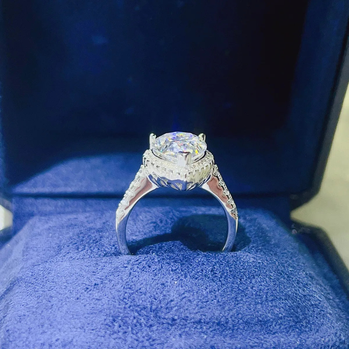 Elegant pear shaped moissanite ring in a velvet display box with intricate band details