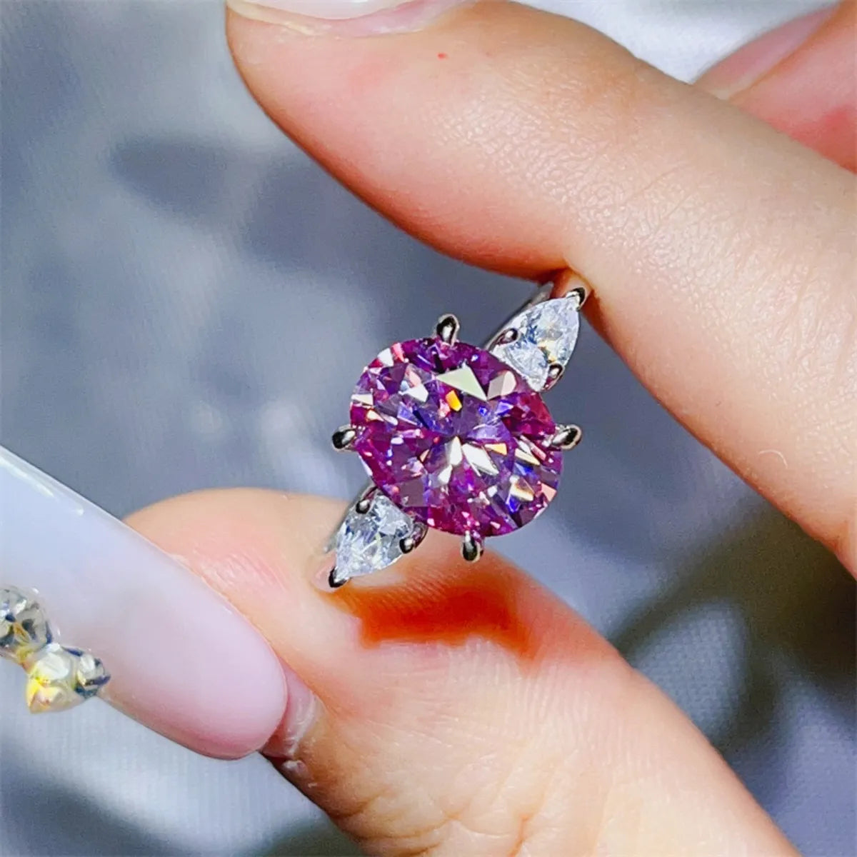 Stunning purple moissanite bridal jewelry ring featuring a central oval stone and marquise side accents