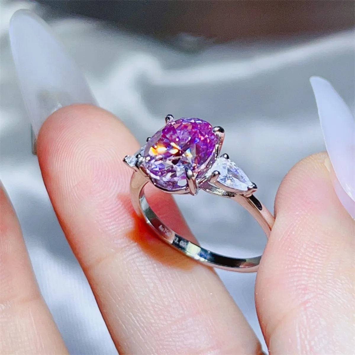 Stunning purple moissanite bridal jewelry ring featuring a central purple stone and two clear side stones
