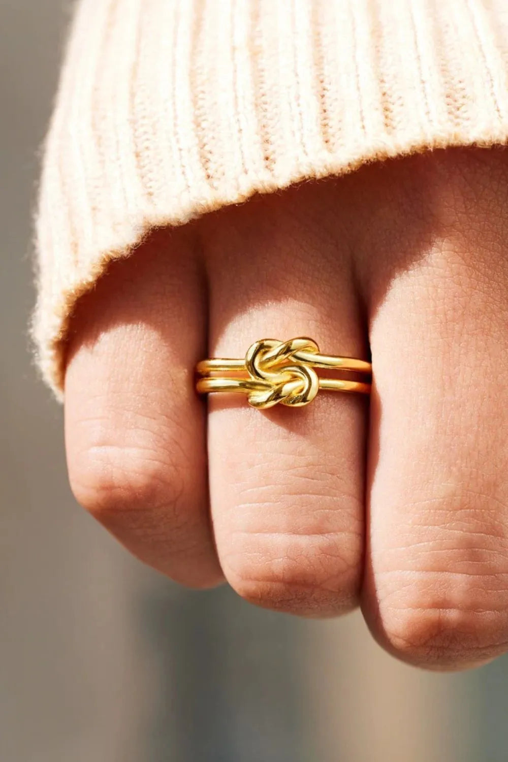 Gold ring featuring a unique silver knot design ring for elegant accessory styling