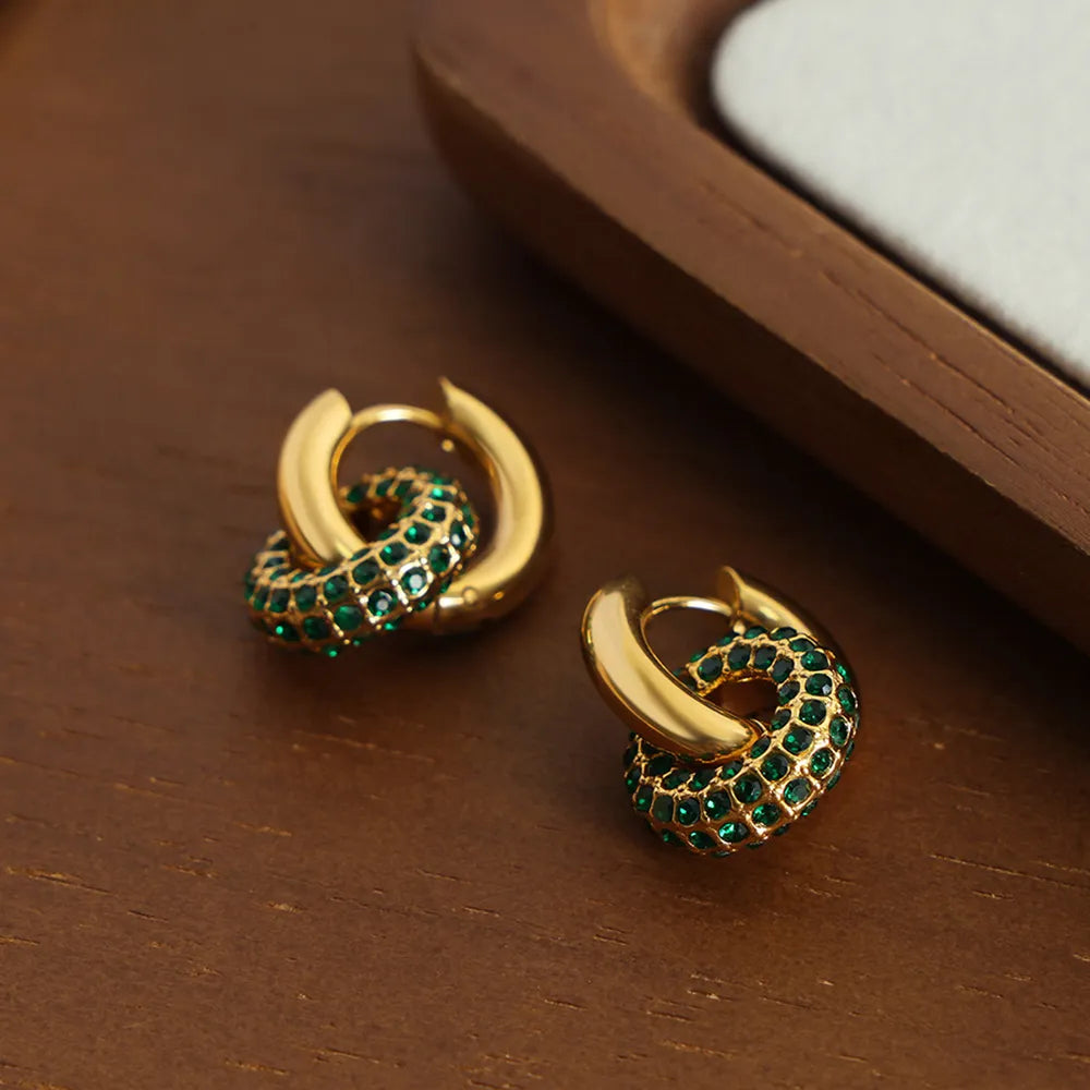 Stylish hoop earrings for women featuring gold tones and emerald detailing for a trendy look