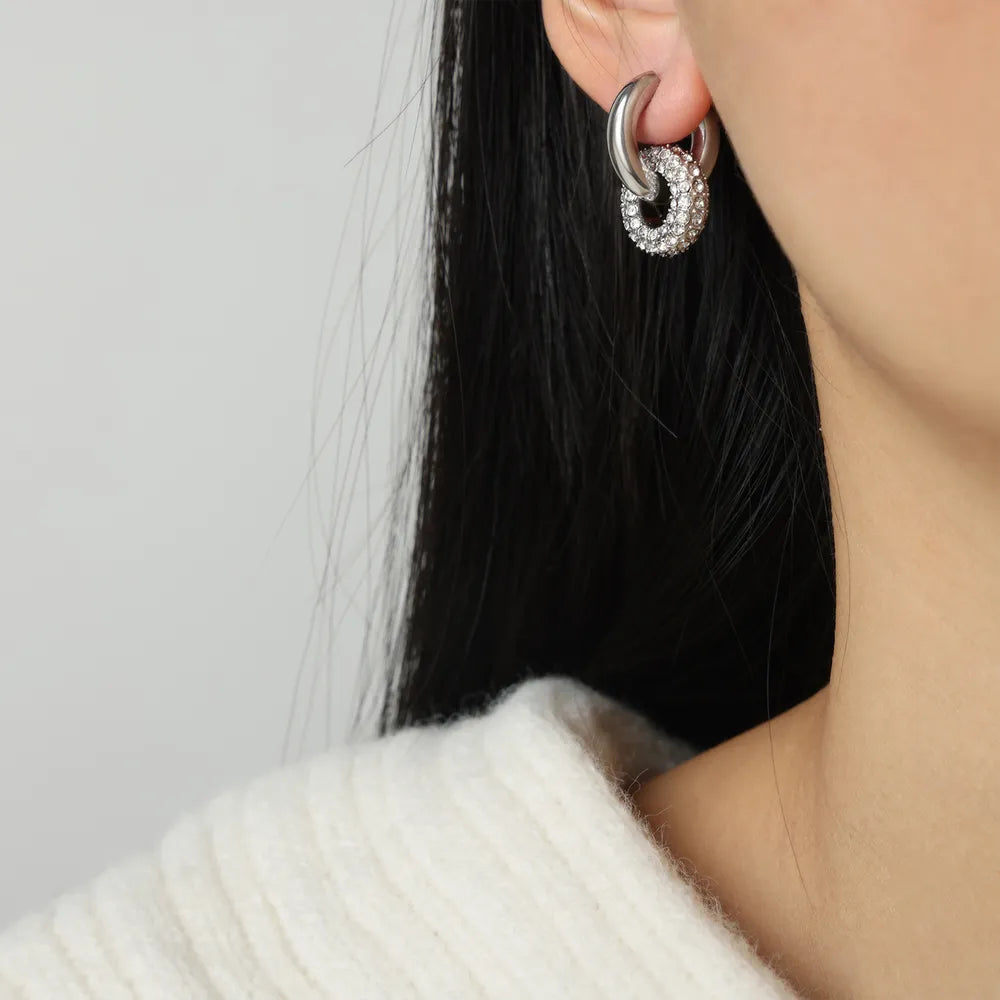 Close-up of stylish hoop earrings for women featuring a unique double design with sparkling accents
