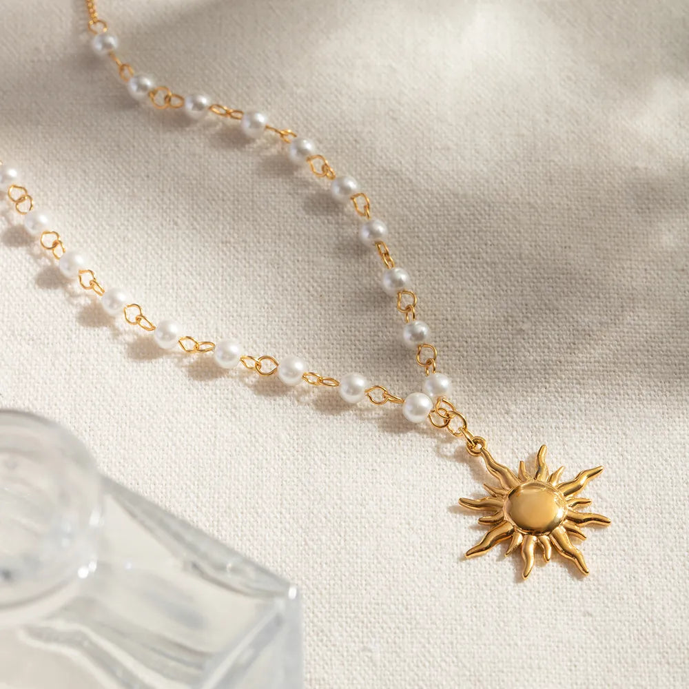 Trendsi sun charm jewelry necklace with pearl accents and a golden sun pendant