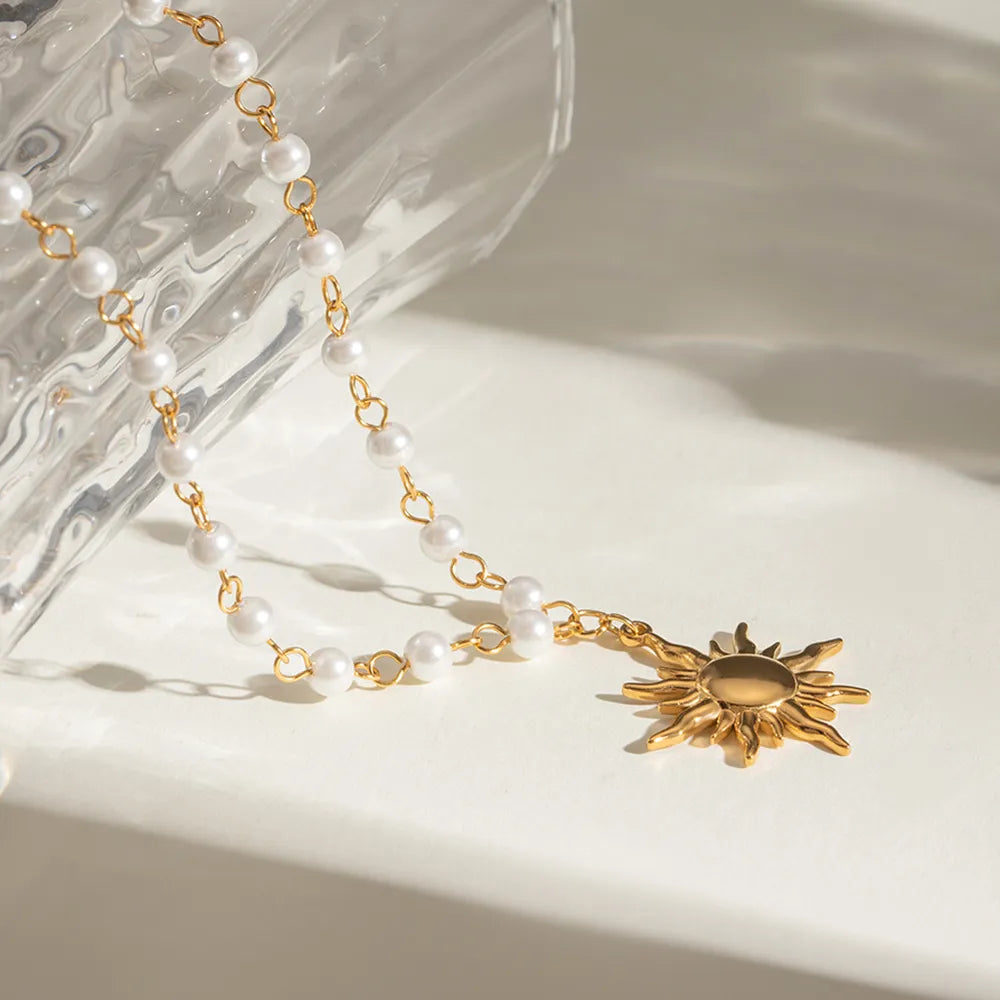 Elegant sun charm jewelry necklace with pearl beads and gold accents for a stylish look
