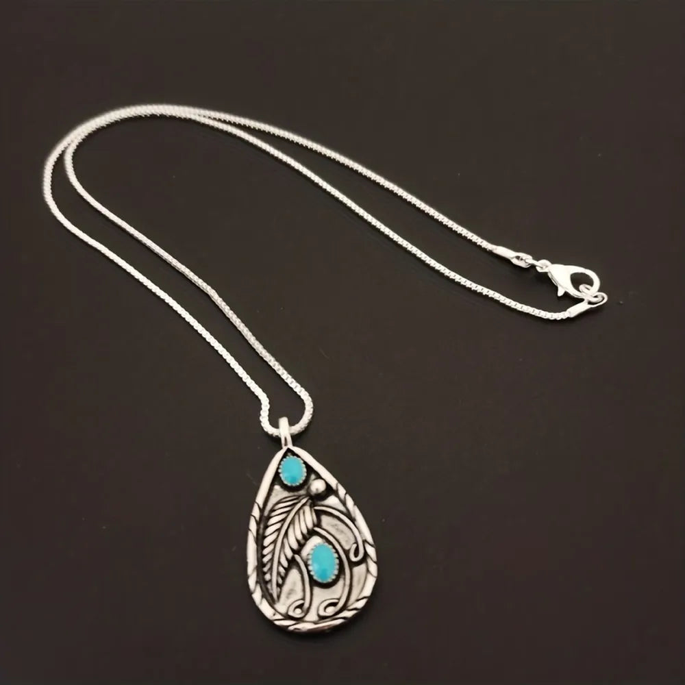 Teardrop turquoise necklace for women featuring a silver leaf design and delicate chain