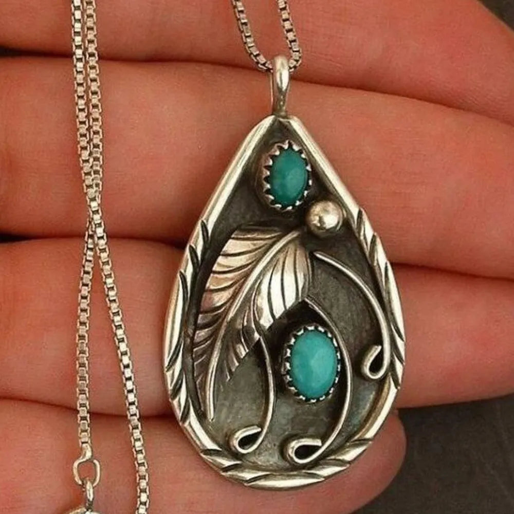Teardrop turquoise necklace for women featuring intricate silver detailing and elegant design