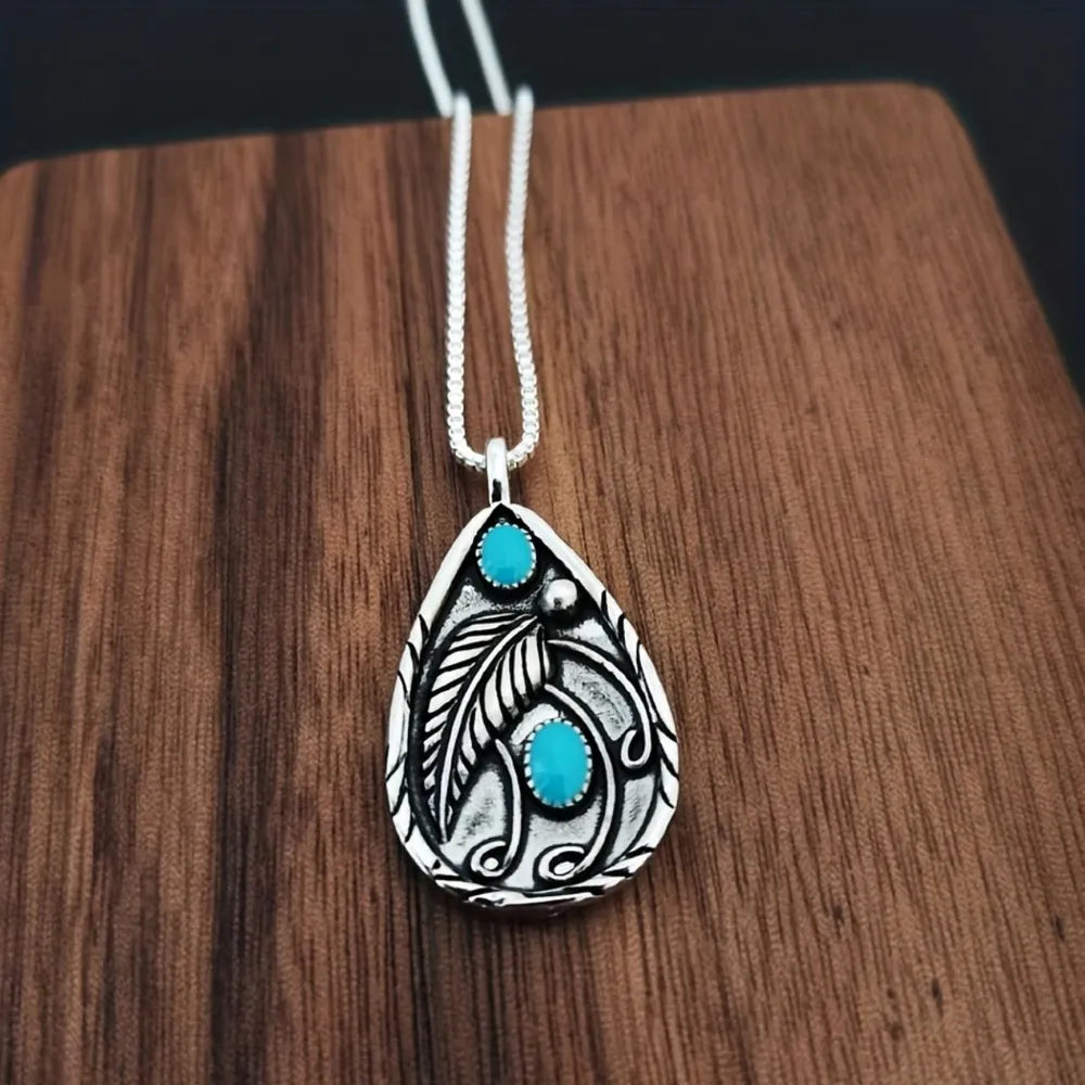 Teardrop turquoise necklace for women featuring intricate silver detailing and natural turquoise stones