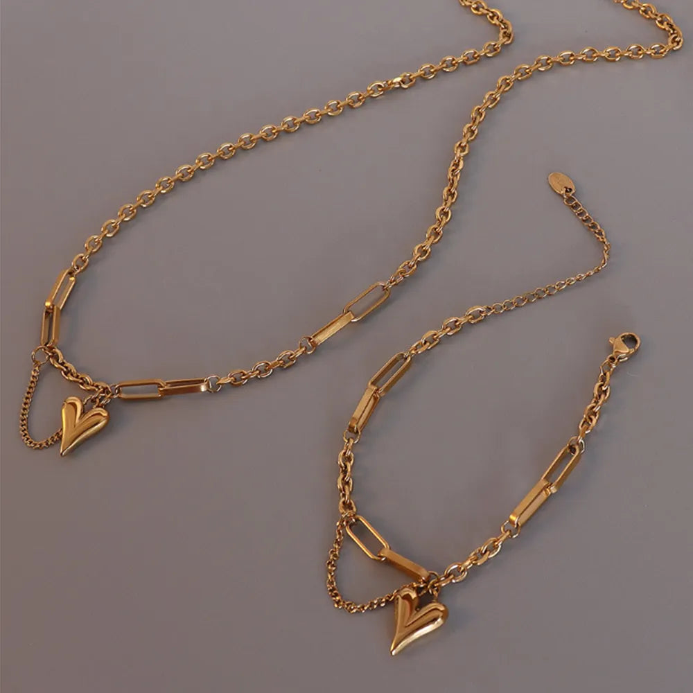 Trendsi titanium heart pendant necklace featuring a gold-tone chain and elegant heart charm