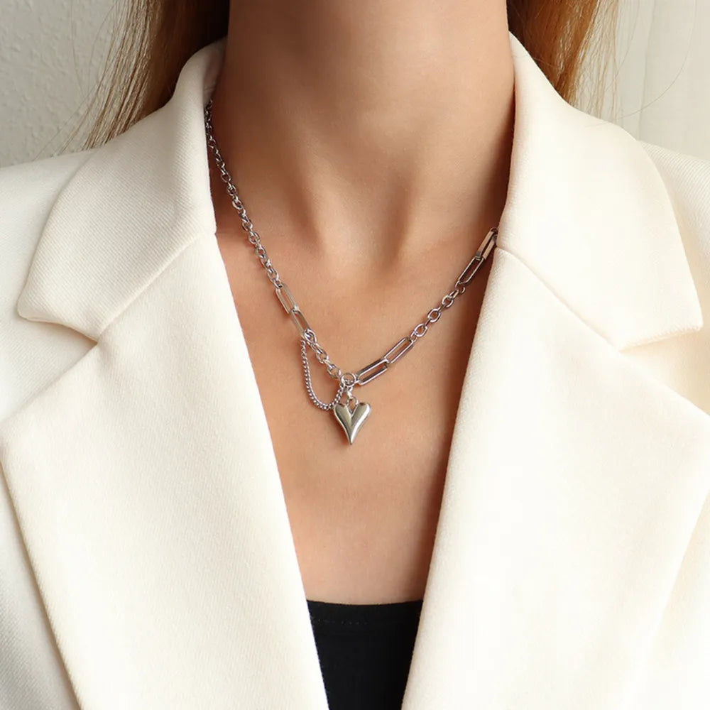 Trendsi titanium heart pendant necklace on a woman, featuring a stylish chain design