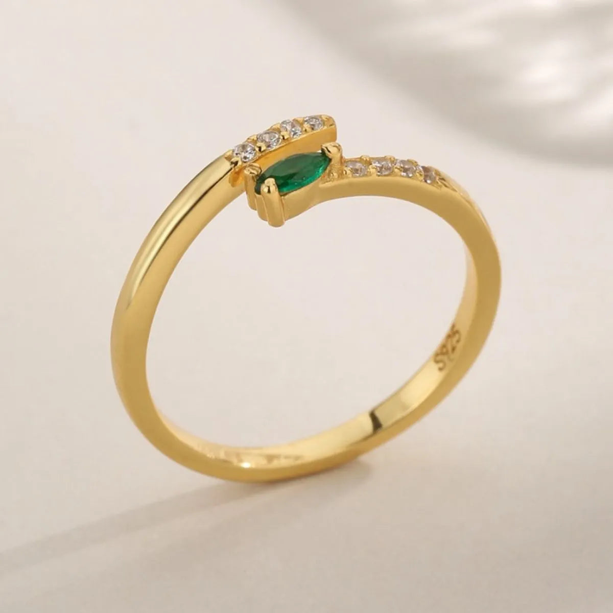 Trendy adjustable ring featuring a green gemstone and sparkling accents for a chic look