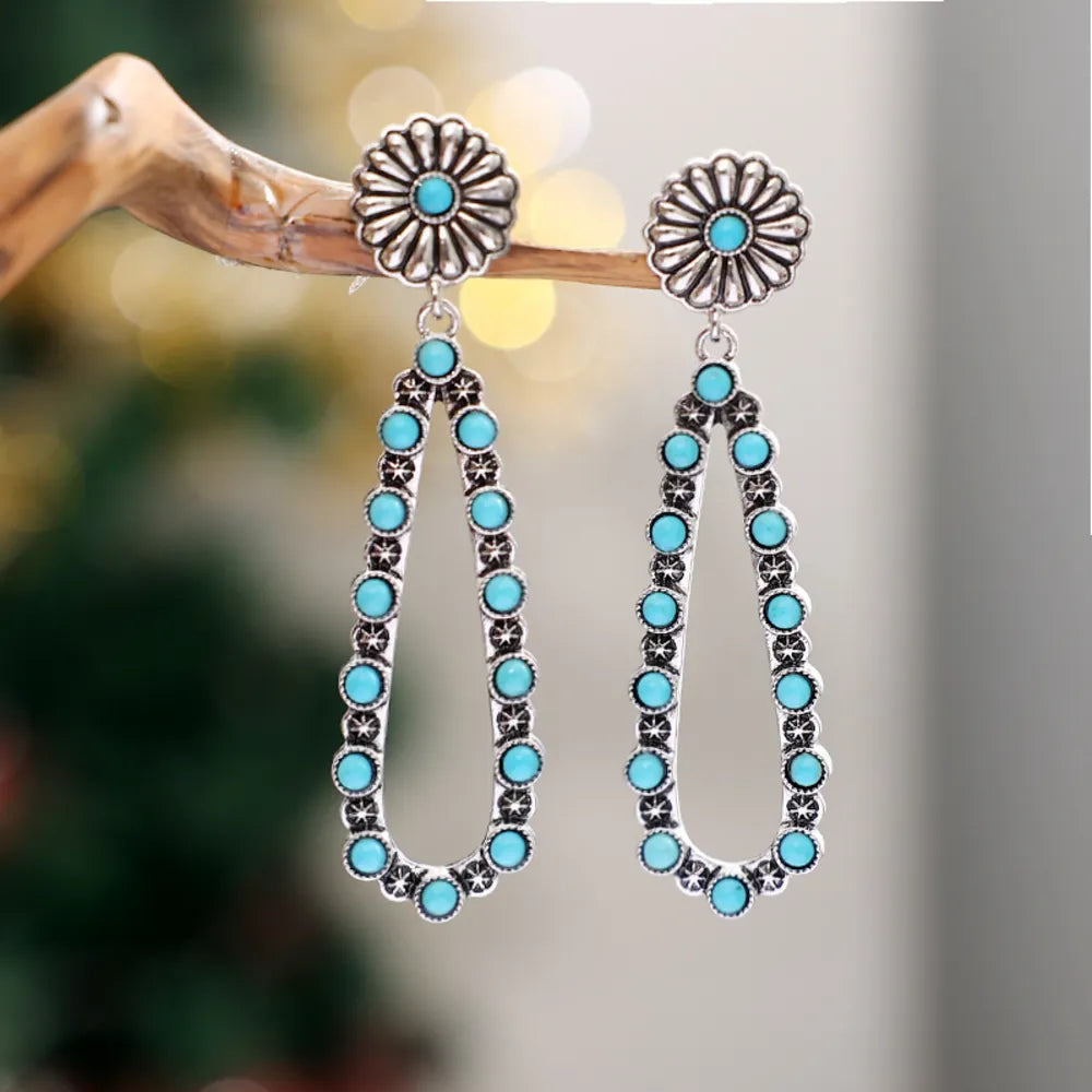 Trendsi turquoise teardrop earrings with silver floral design and rhinestone accents