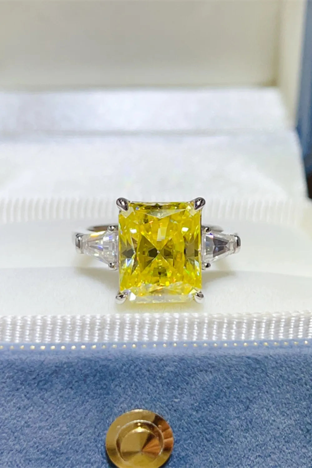 Unique engagement ring moissanite with a yellow center stone and side diamonds in a elegant setting