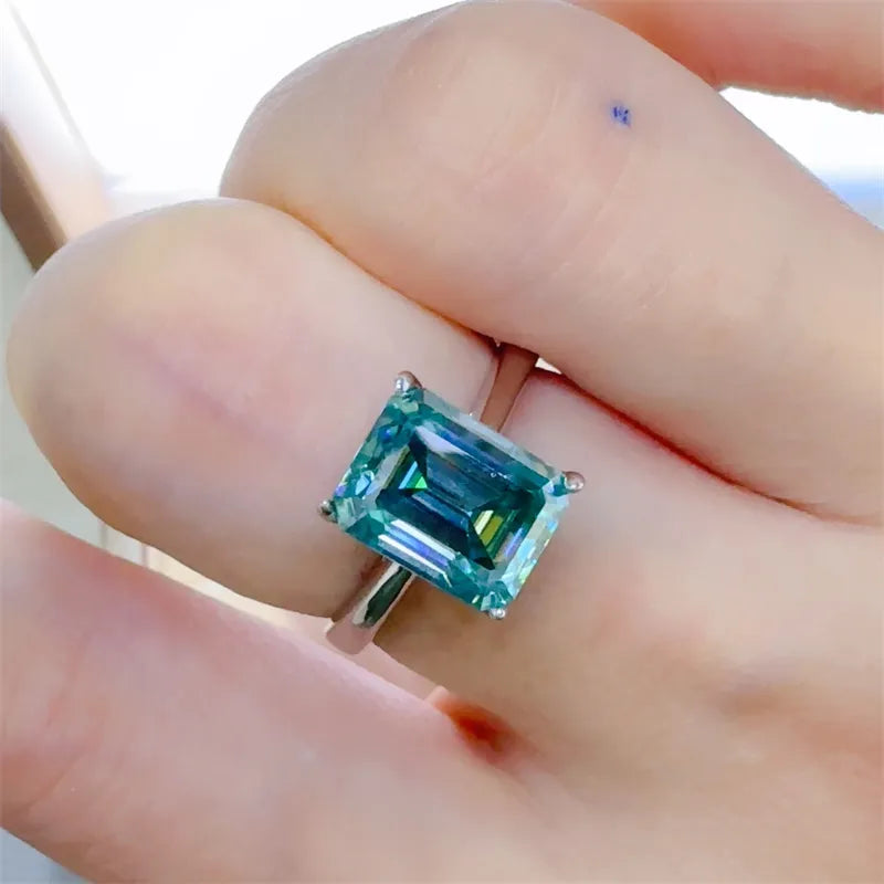 Unique rectangle gemstone ring displayed on a hand with a soft blue hue and elegant setting
