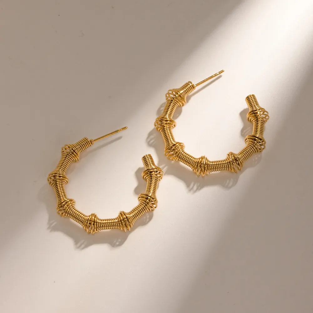 Trendsi 18K gold hoop earrings with a unique twisted design for stylish accessorizing