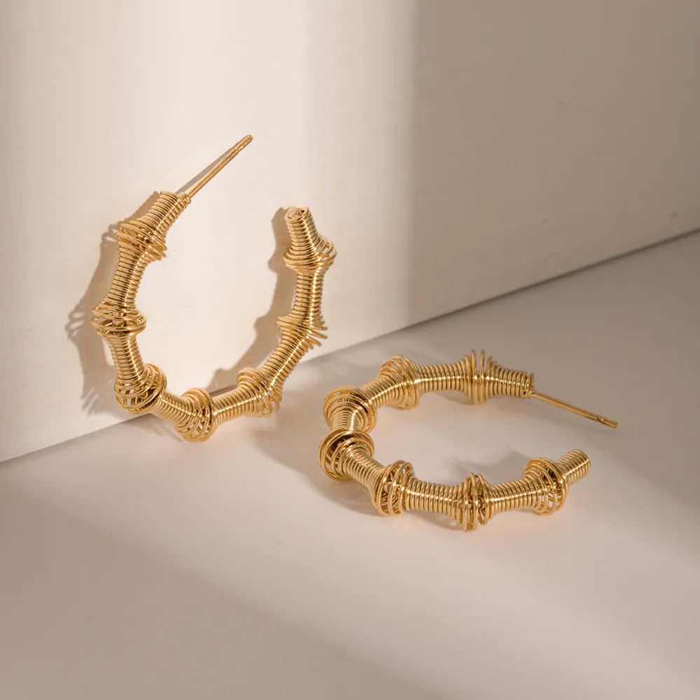 Trendsi 18K gold hoop earrings with a unique twisted design for a stylish look